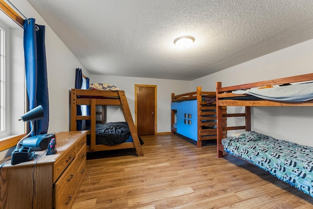 42118 Lowden Ave, Sunrise Twp, MN 55032 - bedroom with light wood-style flooring and a textured ceiling