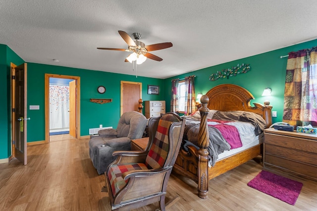 42118 Lowden Ave, Sunrise Twp, MN 55032 - bedroom featuring a textured ceiling, wood finished floors, and ceiling fan