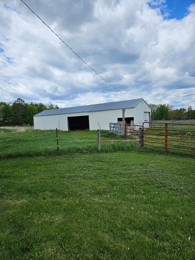 10244 State Highway 87, Blueberry Twp, MN 56464 - view of yard featuring a pole building, a detached garage, an outbuilding, and a view of rural / pastoral area