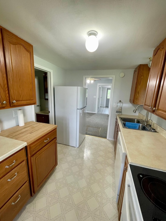 10244 State Highway 87, Blueberry Twp, MN 56464 - kitchen featuring white appliances, light countertops, light floors, and brown cabinetry
