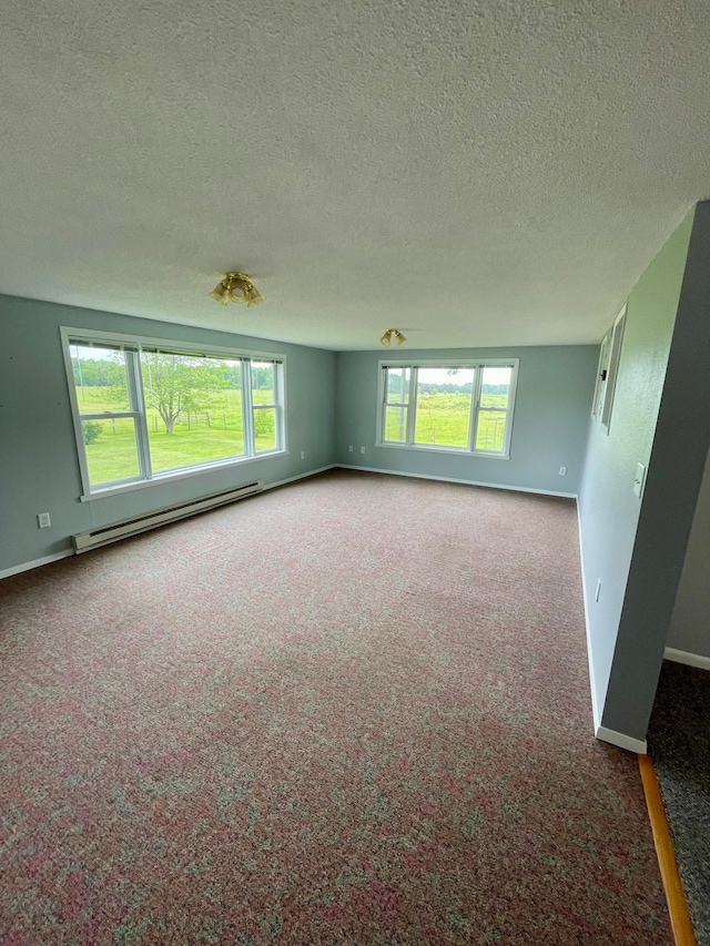 10244 State Highway 87, Blueberry Twp, MN 56464 - carpeted empty room featuring a baseboard heating unit and a textured ceiling