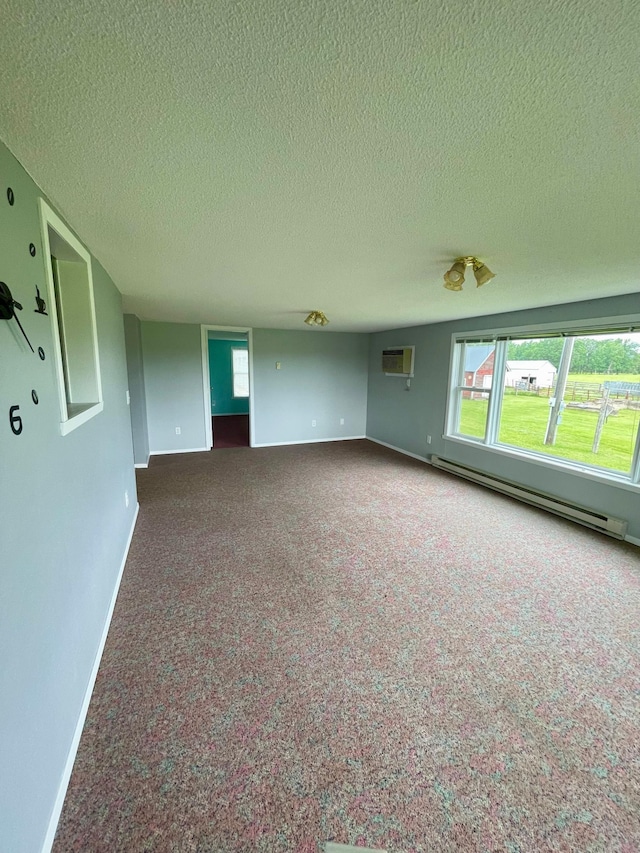 10244 State Highway 87, Blueberry Twp, MN 56464 - spare room featuring baseboard heating, carpet floors, a textured ceiling, and an AC wall unit