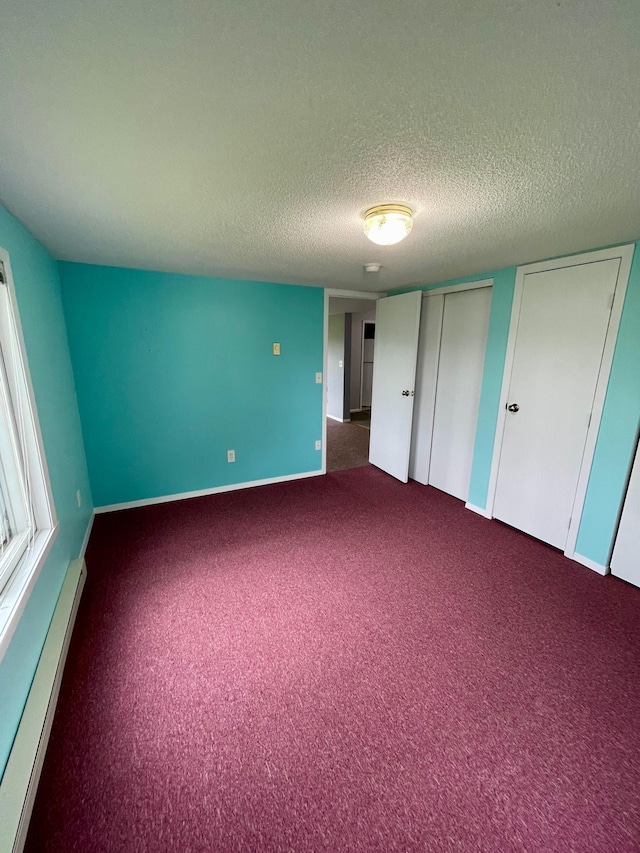 10244 State Highway 87, Blueberry Twp, MN 56464 - unfurnished bedroom with a baseboard heating unit, carpet floors, and a textured ceiling