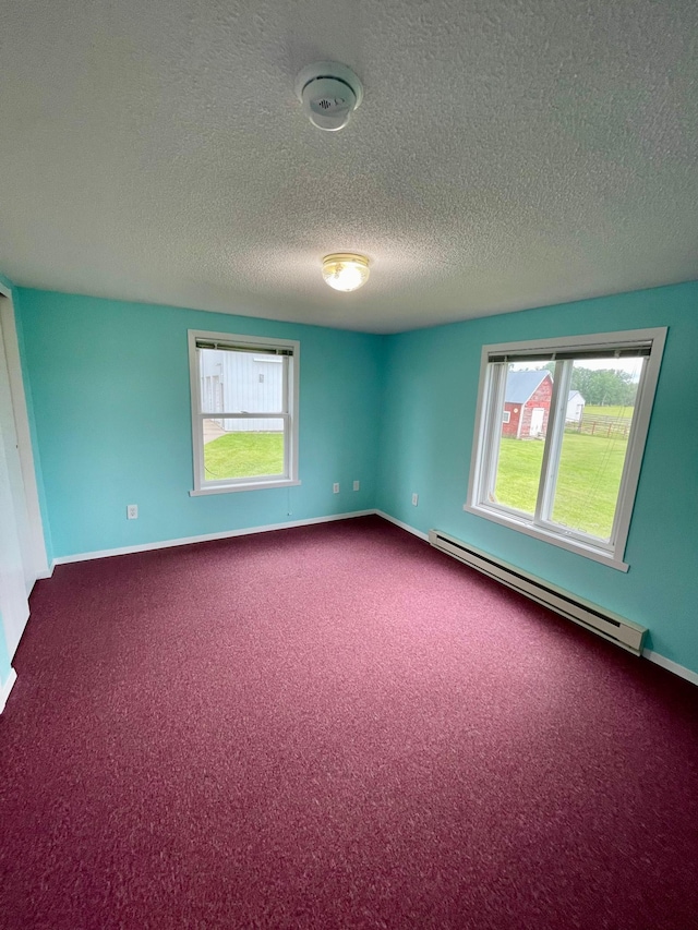 10244 State Highway 87, Blueberry Twp, MN 56464 - unfurnished room featuring a baseboard radiator, a textured ceiling, dark colored carpet, plenty of natural light, and a smoke detector