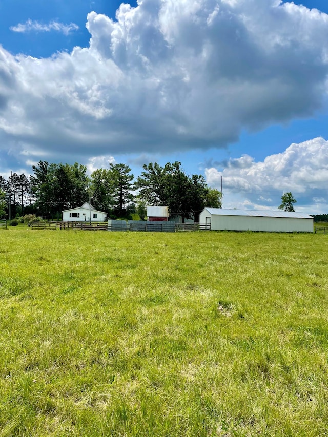 10244 State Highway 87, Blueberry Twp, MN 56464 - view of yard featuring a pole building, an outbuilding, and a view of rural / pastoral area