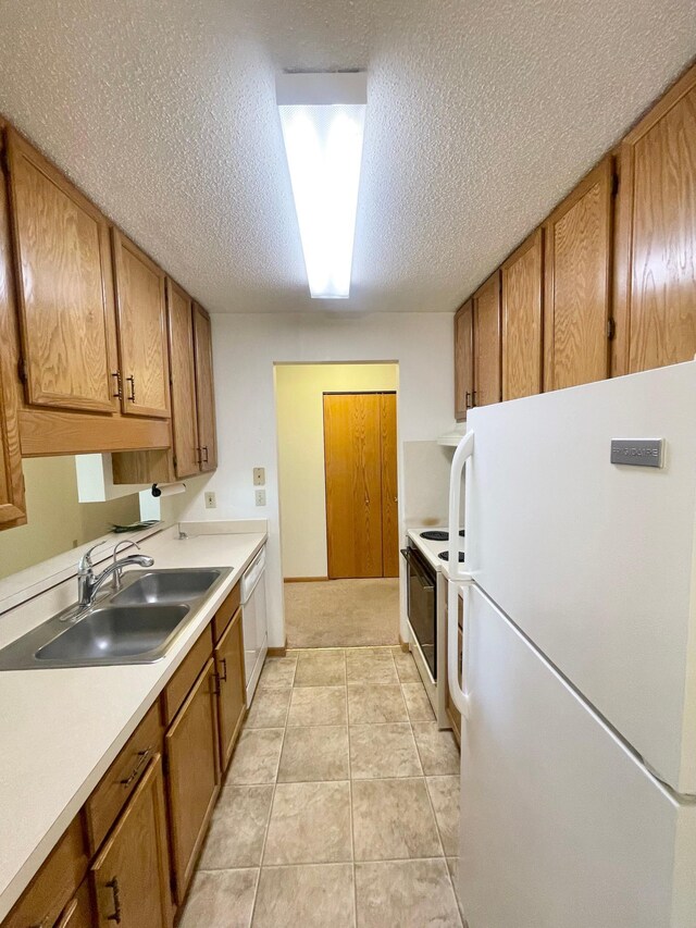 401 County Road 5 Unit 102, Springfield, MN 56087 - kitchen featuring white appliances, brown cabinetry, a textured ceiling, and light countertops