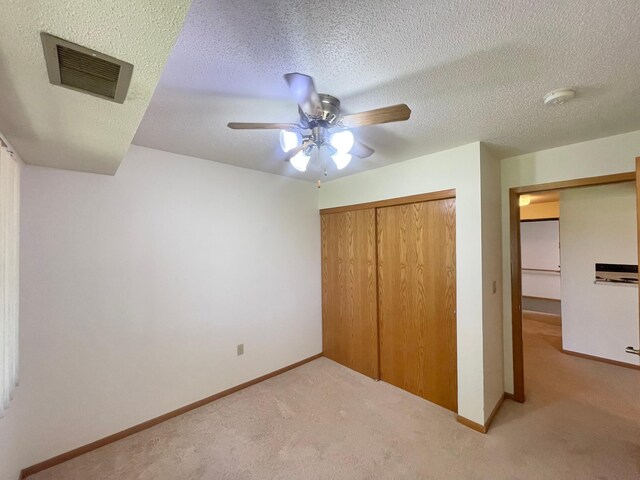 401 County Road 5 Unit 102, Springfield, MN 56087 - unfurnished bedroom featuring light colored carpet, a closet, a ceiling fan, and a textured ceiling
