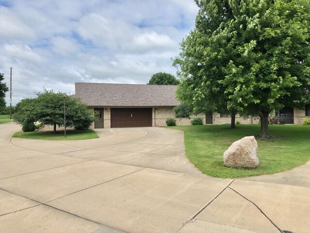 401 County Road 5 Unit 102, Springfield, MN 56087 - view of front facade with concrete driveway, an attached garage, a front yard, and brick siding