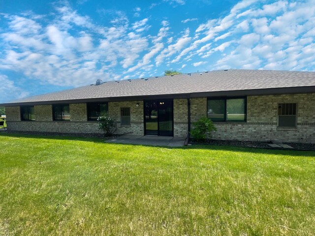 401 County Road 5 Unit 102, Springfield, MN 56087 - view of front of property with brick siding, a front yard, and roof with shingles