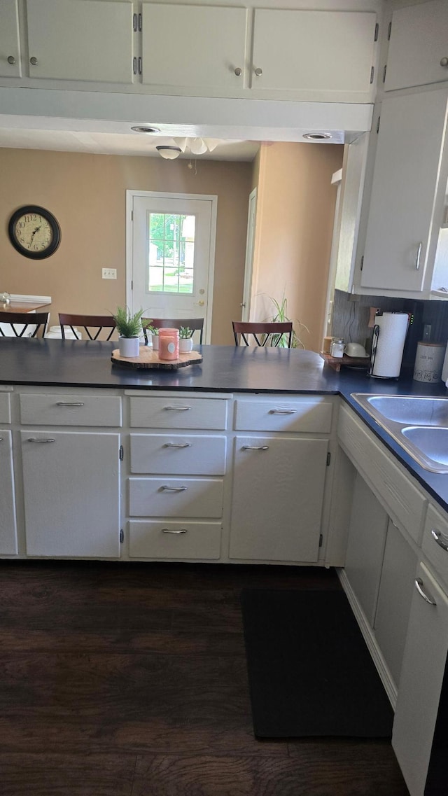 524 1st Ave SE, Wells, MN 56097 - kitchen with white cabinets, dark wood-style floors, and dark countertops