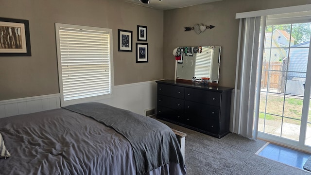 524 1st Ave SE, Wells, MN 56097 - bedroom featuring carpet, access to outside, and a wainscoted wall