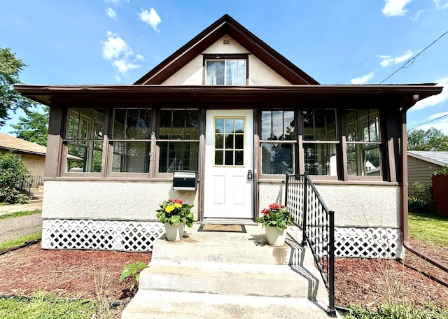 2112 Manitou Ave, Saint Paul, MN 55119 - view of front facade with stucco siding and a sunroom
