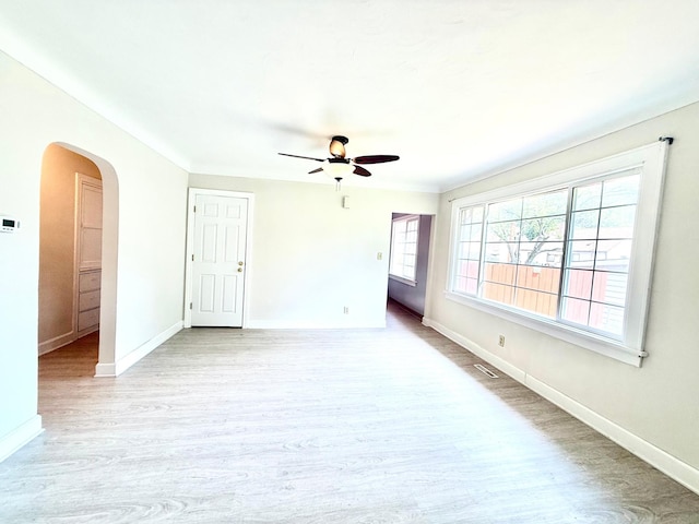 2112 Manitou Ave, Saint Paul, MN 55119 - unfurnished room featuring ceiling fan, arched walkways, and light wood-style flooring
