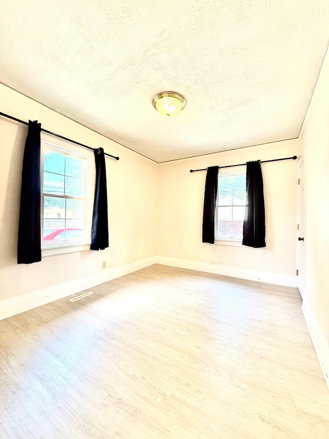 2112 Manitou Ave, Saint Paul, MN 55119 - unfurnished room featuring light wood-style flooring and a textured ceiling