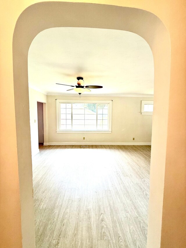 2112 Manitou Ave, Saint Paul, MN 55119 - unfurnished room featuring arched walkways, ceiling fan, and wood finished floors