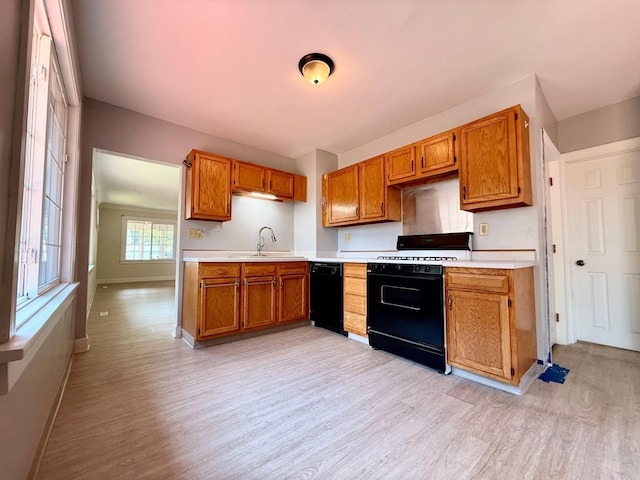 2112 Manitou Ave, Saint Paul, MN 55119 - kitchen with gas range, black dishwasher, light wood-type flooring, and light countertops