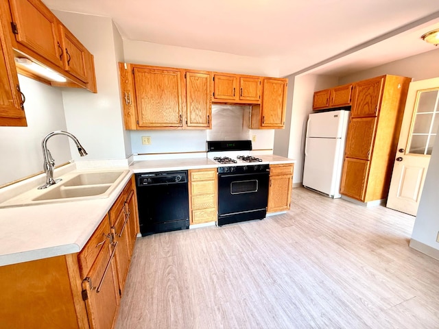 2112 Manitou Ave, Saint Paul, MN 55119 - kitchen with freestanding refrigerator, black dishwasher, range with gas stovetop, light wood-type flooring, and light countertops