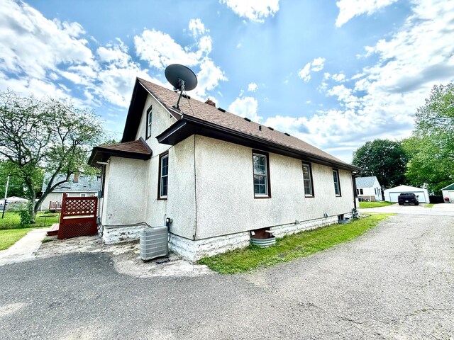 2112 Manitou Ave, Saint Paul, MN 55119 - view of property exterior with stucco siding and roof with shingles