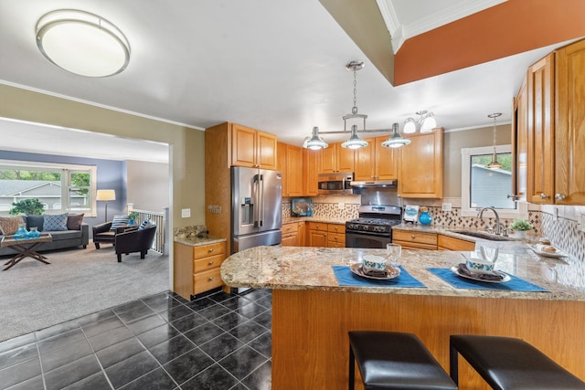 6636 Lancaster Ln N, Maple Grove, MN 55369 - kitchen with appliances with stainless steel finishes, a peninsula, ornamental molding, open floor plan, and decorative backsplash