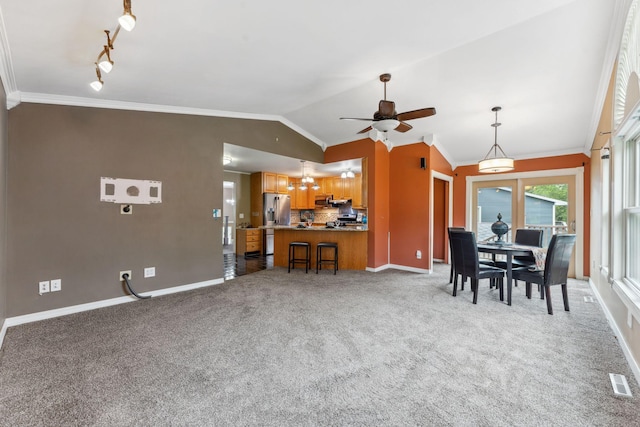6636 Lancaster Ln N, Maple Grove, MN 55369 - dining room featuring vaulted ceiling, a ceiling fan, ornamental molding, light carpet, and track lighting