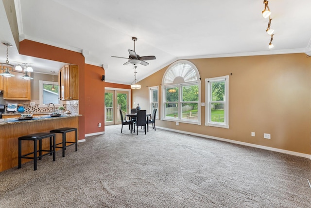 6636 Lancaster Ln N, Maple Grove, MN 55369 - kitchen with ornamental molding, ceiling fan, tasteful backsplash, carpet flooring, and a kitchen breakfast bar