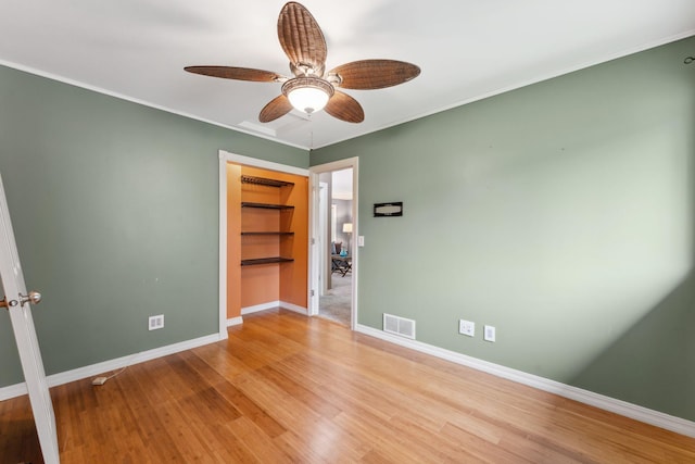 6636 Lancaster Ln N, Maple Grove, MN 55369 - unfurnished room with ceiling fan, wood finished floors, and ornamental molding