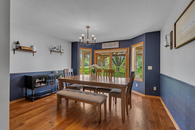 1805 7th Ave N, Sartell, MN 56377 - dining room with a chandelier, wood-type flooring, and a textured ceiling