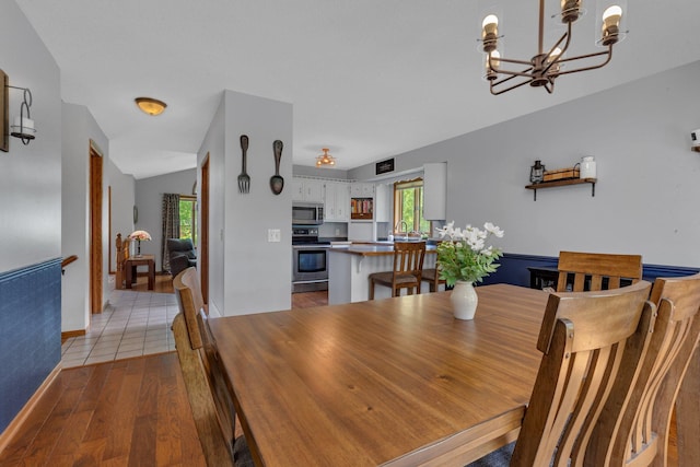 1805 7th Ave N, Sartell, MN 56377 - dining space featuring a chandelier and light wood finished floors