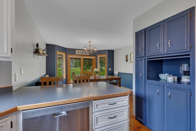 1805 7th Ave N, Sartell, MN 56377 - kitchen featuring stainless steel dishwasher, blue cabinets, a chandelier, a peninsula, and a textured ceiling