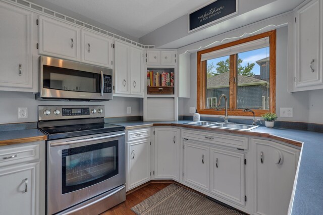 1805 7th Ave N, Sartell, MN 56377 - kitchen with appliances with stainless steel finishes, white cabinetry, and dark wood-style floors