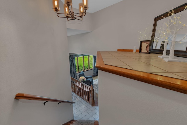 1805 7th Ave N, Sartell, MN 56377 - stairs featuring a chandelier, a towering ceiling, and tile patterned floors