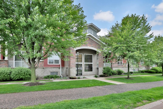 17417 72nd Ave N Unit 205, Maple Grove, MN 55311 - obstructed view of property with brick siding and a front yard