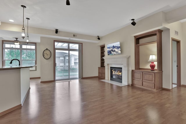 17417 72nd Ave N Unit 205, Maple Grove, MN 55311 - unfurnished living room featuring ceiling fan, a tile fireplace, wood finished floors, and recessed lighting