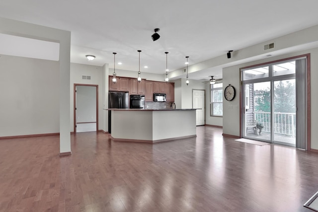 17417 72nd Ave N Unit 205, Maple Grove, MN 55311 - kitchen featuring black appliances, open floor plan, wood finished floors, an island with sink, and recessed lighting