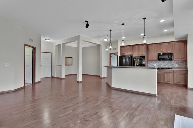 17417 72nd Ave N Unit 205, Maple Grove, MN 55311 - kitchen featuring black appliances, tasteful backsplash, light wood-style flooring, recessed lighting, and decorative light fixtures