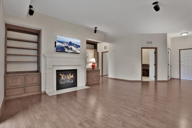 17417 72nd Ave N Unit 205, Maple Grove, MN 55311 - unfurnished living room featuring a glass covered fireplace and wood finished floors