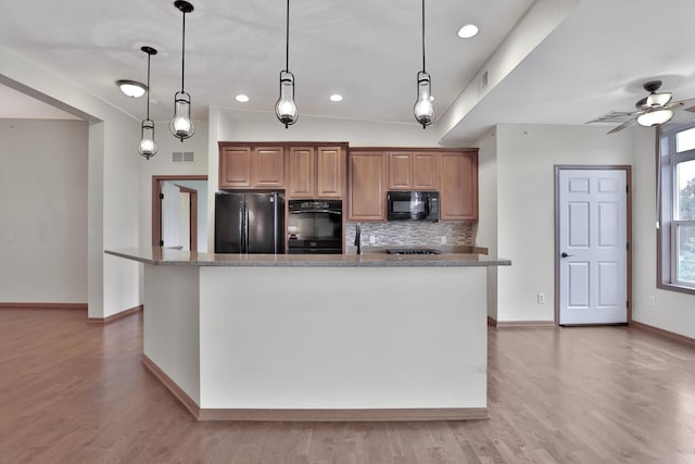 17417 72nd Ave N Unit 205, Maple Grove, MN 55311 - kitchen with black appliances, decorative backsplash, light wood finished floors, a ceiling fan, and recessed lighting