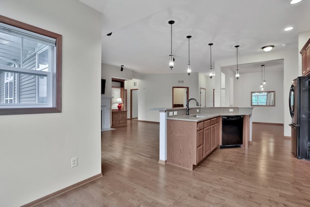 17417 72nd Ave N Unit 205, Maple Grove, MN 55311 - kitchen featuring black appliances, light wood-type flooring, open floor plan, an island with sink, and pendant lighting