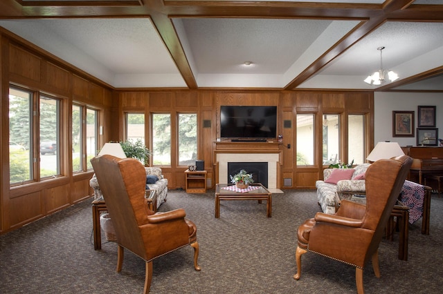 1415 Lake St Unit 114, Alexandria, MN 56308 - living room with a chandelier, carpet, wood walls, beam ceiling, and a fireplace