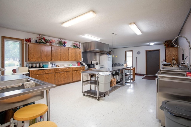 1415 Lake St Unit 114, Alexandria, MN 56308 - kitchen with brown cabinetry, light flooring, a textured ceiling, and light countertops