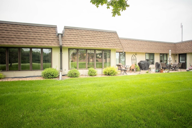 1415 Lake St Unit 114, Alexandria, MN 56308 - rear view of property featuring mansard roof, a yard, and roof with shingles