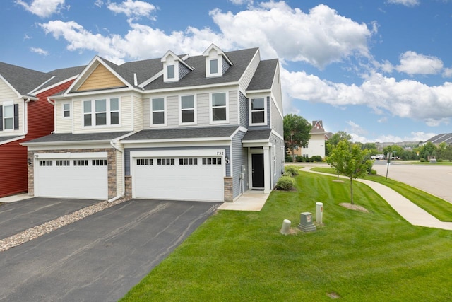 732 Wildflower Ln, Chanhassen, MN 55317 - view of front of house with asphalt driveway, an attached garage, a front yard, and stone siding