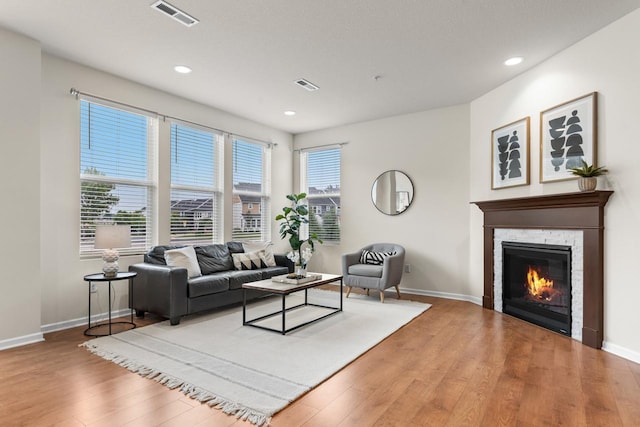732 Wildflower Ln, Chanhassen, MN 55317 - living area featuring wood finished floors, recessed lighting, and a stone fireplace