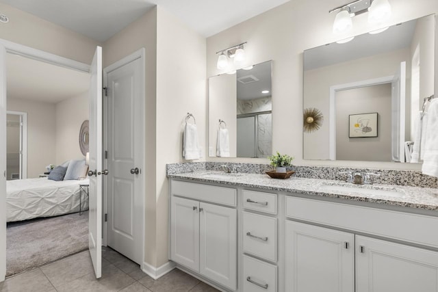 732 Wildflower Ln, Chanhassen, MN 55317 - ensuite bathroom with double vanity, a shower stall, and tile patterned flooring