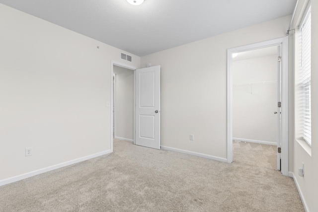 732 Wildflower Ln, Chanhassen, MN 55317 - unfurnished bedroom with carpet, a spacious closet, a closet, and multiple windows