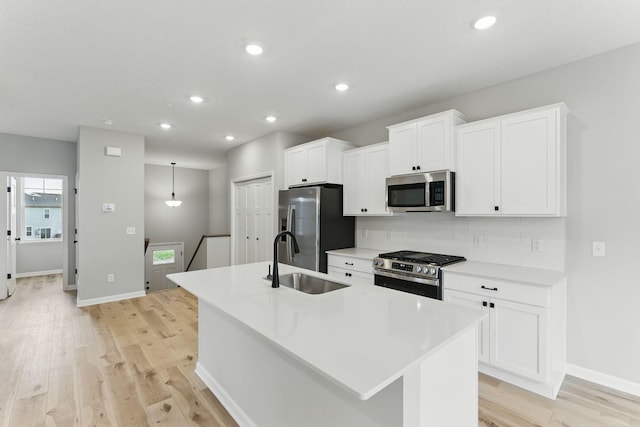 2720 Kepler Ave NE, Saint Michael, MN 55376 - kitchen featuring stainless steel appliances, an island with sink, decorative backsplash, light wood-style floors, and recessed lighting