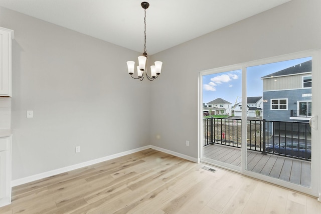 2720 Kepler Ave NE, Saint Michael, MN 55376 - unfurnished dining area with light wood finished floors, a chandelier, and a residential view