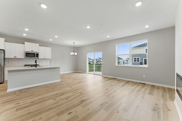 2720 Kepler Ave NE, Saint Michael, MN 55376 - kitchen featuring appliances with stainless steel finishes, a chandelier, recessed lighting, light wood-style floors, and white cabinetry