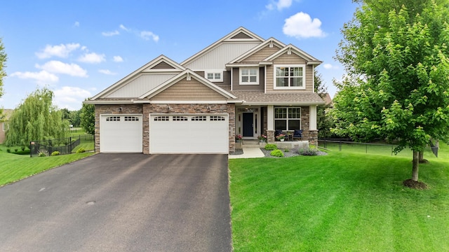19550 Albany Cir NW, Elk River, MN 55330 - craftsman house with asphalt driveway, a porch, stone siding, and an attached garage