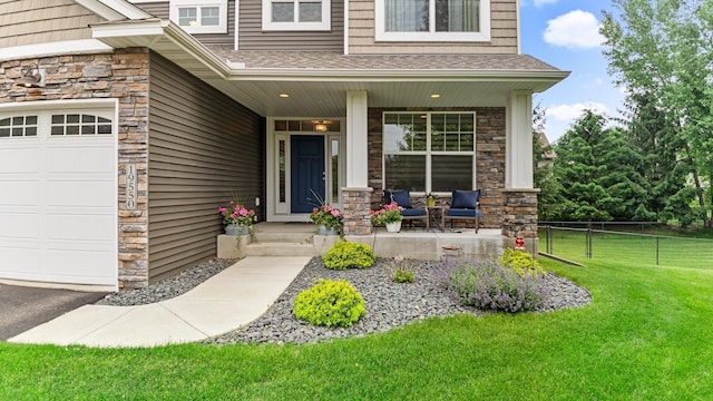 19550 Albany Cir NW, Elk River, MN 55330 - entrance to property featuring covered porch, stone siding, and a shingled roof